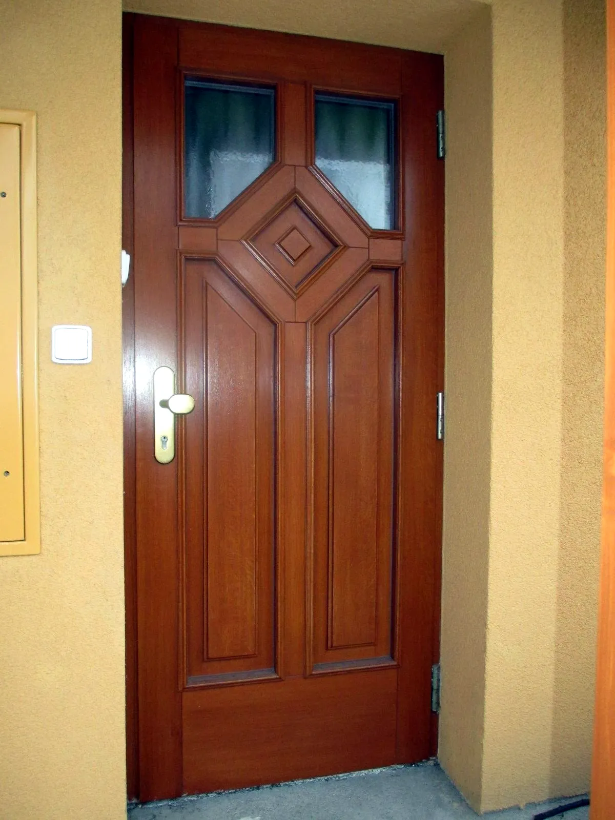 Dřevěné vchodové dveře s ozdobnou výplní
